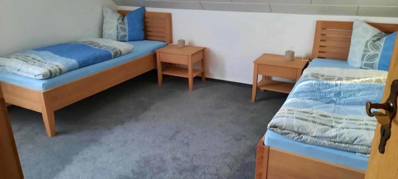 Schlafzimmer mit zwei Einzelbetten und je einem Nachttisch.